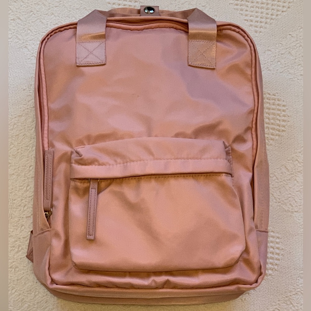 Blush colored light weight backpack with padded shoulder straps 15”x 13”